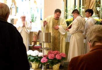 Father Eric Gruber blesses the water at St. John Fisher. (Photo by John Simitz)