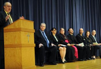 Mike Reinert, left, WFMZ-TV Berks Edition, welcomes diocesan officials, students and their families to the award ceremony. Others are, from left: Fromuth; Tesche; Bishop Schlert; Father Stephan Isaac, BCHS chaplain; Tony Balistrere, deputy superintendent for Catholic education; Alice Einolf, principal of BCHS; and Acampora.