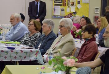 Focusing on the presentation are, from left front, Robert Ross, Jeanne Maholick, MaryLou Ross, Joan Balik, AnnaMarie German and Father Michael Kon.