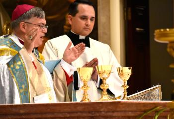 Bishop of Allentown Alfred Schlert, left, consecrates the chalices during Holy Hour for Ordinandi with the assistance of Father Keith Mathur, assistant in the Diocesan Curia and director of the Diocesan Office for Divine Worship.