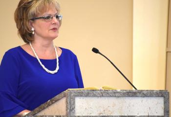 June Doncsecz offers the second reading. (Photo by John Simitz.)