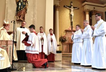 Bishop Schlert, left, examines the candidates during Examination and Promise of the Elect. (Photo by John Simitz.)