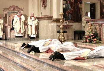 The candidates prostrate themselves before the altar as the  Litany of the Saints is chanted. (Photo by John Simitz.)