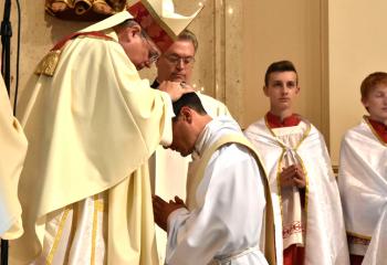 Bishop Schlert, left, ordains Father Esposito to the priesthood (Photo by John Simitz.)