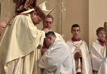 Bishop Schlert, left, ordains Father Wehr to the priesthood. (Photo by John Simitz.)
