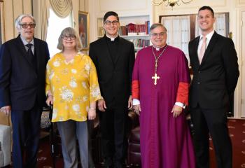 Father Esposito, center, meets with Bishop Schlert, second from right, and his family on the day of his ordination. From left are his parents, Joseph and Debra Esposito, and his brother, Justin Esposito. 
