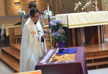 Father Eric Tolentino blesses the awards.