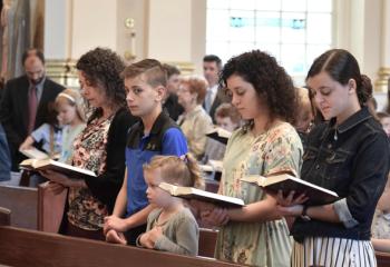 Families from the homeschool community sing at the beginning of the morning liturgy.
