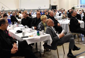 Members of the Serra Clubs, clergy and guests celebrate the newly ordained priests at St. Mary, Hamburg.