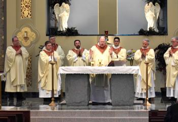 Monsignor David James, center, celebrates Mass with, from left: Father David Kozak, Monsignor Walter Scheaffer, Father Eugene Ritz, Father Zachary Wehr, Father Donald Cieniewicz, Father Adam Sedar, Father Giuseppe Esposito, Father John Maria, Father George Winne and Father Eric Arnout.