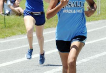 Alesha Patel, LaSalle Academy, Shillington, heads for the finish, followed by Giana Curran, Our Lady of Perpetual Help, Bethlehem, as they run in the seventh-grade girls 400 meters race.