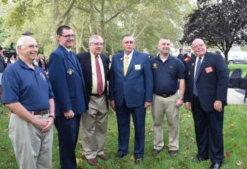 Members of the Knights of Columbus attend the ceremony. Some knights helped paint the school at various times.