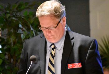 Malta member John Turnbach serves as lector during the first reading.