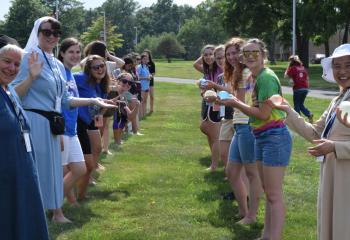 Women religious and young women prepare for a game of water balloon toss at Fiat Days at DeSales University, Center Valley.