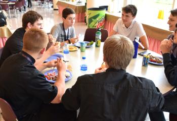 Diocesan seminarians and young men enjoy conversation and lunch together at Quo Vadis.