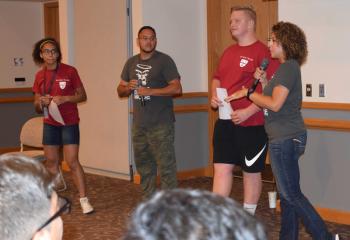 Yessenia Hernandez, right, and Alex Hernandez, second from left, lead a warm-up exercise with participants in Quo Vadis and Fiat Days.