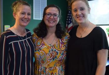 Little, center, is welcomed by Annie Sarlo, left, interim secretary of the Secretariat for Catholic Life and Evangelizaton, and Abby Lutz.