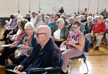 Soldiers, family, friends and faithful witness the ceremony at Curtis Armory, Allentown.