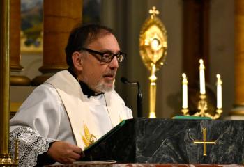 Father David Kozak, pastor, offers the homily during the devotions.
