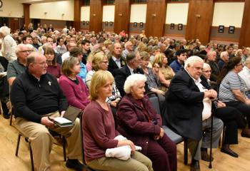 The faithful fill the cathedral’s Parish Activity Center for the evening talk.