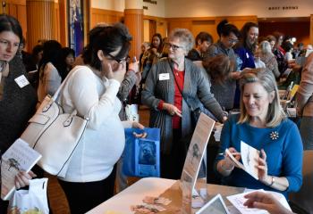 Christmyer, right, signs a copy of her book during the conference. (Photo by John Simitz)