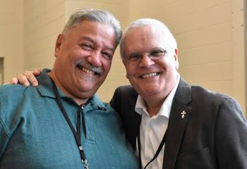 Deacon Ricardo Reyes, who serves Our Lady Help of Christians, Allentown, left, meets his old friend Deacon Kandra.