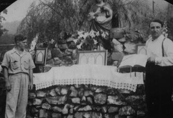 Placidio Guido LaRizzio, left, and Monsignor Agnello Angelini stand before the Grotto, Our Lady of Lourdes Shrine that was constructed by LaRizzio.