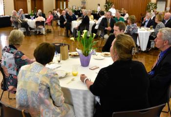 Members of the Legacy Society welcome new members during brunch at St. Thomas More, Allentown.
