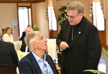 Bill Stracca greets Bishop Schlert.