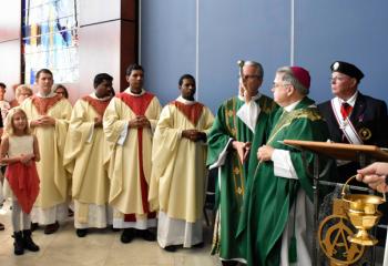 Bishop of Allentown Alfred Schlert blesses the atrium inside the new parish center.