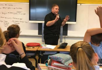 Father Zachary Wehr teaches a religion class at St. Catharine of Siena School, Reading.