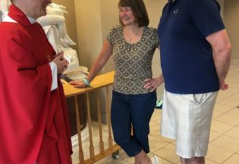 Father John Maria chats with Jon and Martina Peace, directors of youth ministry at St. Thomas More, Allentown, after a weekday morning Mass.