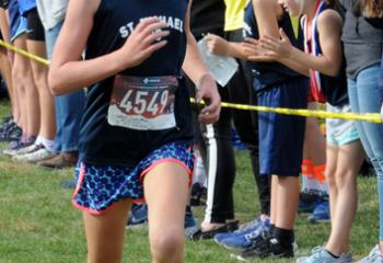 Caelee Maye Lenhart from St. Michael the Archangel School, Bethlehem-Coopersburg heads to the finish to win the fifth- to sixth-grade girls’ race. (Photo by Ed Koskey)