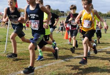 Third- and fourth-grade boys’ race during the meet. Gene Decker expressed his enthusiasm for the meet, noting the activity “shows children living their Catholic values.” (Photo by Ed Koskey)