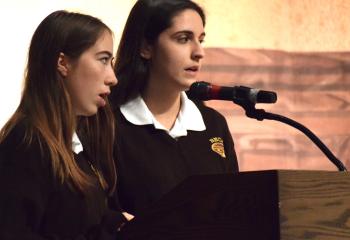 Bethlehem Catholic students Deirdre Kelly, left, and Samantha Hoffman sing the opening hymn at the morning liturgy.