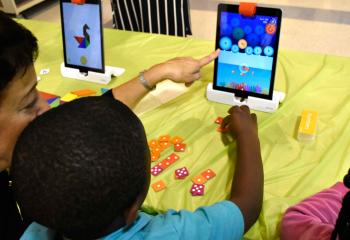 Zelie Zudie plays an educational game on one of the newly acquired iPads.