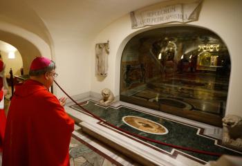 Bishop Schlert prays at the tomb of St. Peter the Apostle at St. Peter’s Basilica at the Vatican Nov. 29.  (CNS photo/Paul Haring) 