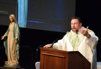 Father Adam Sedar preaches the homily at Mass.