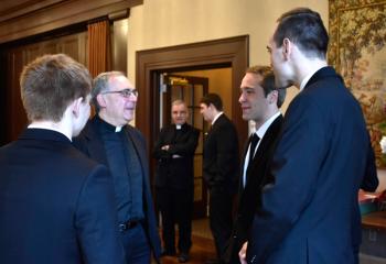Father David Loeper, second from left, catches up with, from left, Kolbe Eidle, Aaron Scheidel and Matthew Kuna. Behind them are Father Anthony Mongiello and Keaton Eidle.  cutline 5