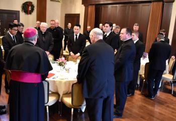 Bishop Schlert prays grace before the meal, and offers words of encouragement and gratitude.