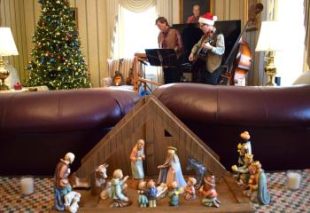 Playing Christmas music in the background are Dr. Russ Rentler and his brother Bob. Musical entertainment was featured at many of the homes on the tour.