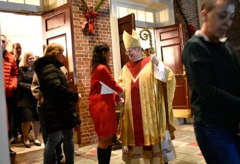 Bishop Schlert greets worshippers after Mass.