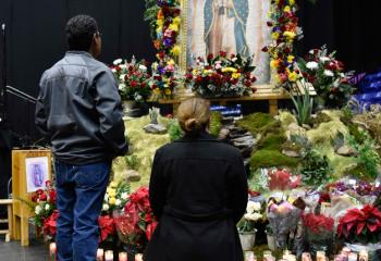 Praying at the shrine for Our Lady of Guadalupe. / Orando en el santuario por Nuestra Señora de Guadalupe.