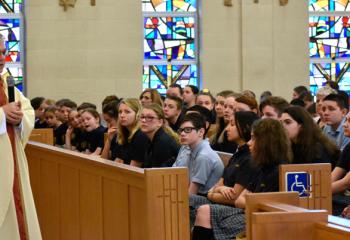 Bishop Schlert talks to the students during the Catholic Schools Week Mass at Holy Family School, Nazareth.