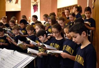 Holy Family School student sing the entrance hymn.