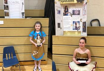 Immaculate Conception Academy, Douglassville students posing for a wax figure activity are Lakota Keeler as Pocahontas, left, and Skylar Cava as Misty Copeland.