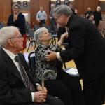 Bishop-elect Schlert greets his parents at his news conference. (John Simitz)