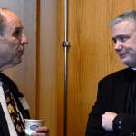 A participant speaks to Father Larry Richards, keynote presenter at Spirit 2013