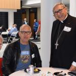 Bishop Cisneros, right, talks with Jerome Stephen, left and Salvador Espinosa during the lunch break.