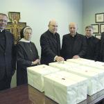Diocesan officials and clergy witness the final seal in February 2006 on six boxes of materials and documents supporting the cause for canonization of the Rev. Walter J. Ciszek, S.J., a priest from the Diocese of Allentown. From left are the Rev. Msgr. Gerald E. Gobitas Th.M., Chancellor and Notary for the cause; Sr. Albertine Dawidowski, O.S.F., Director of the Fr. Ciszek Center in Shenandoah; the Most Rev. Edward P. Cullen, D.D., Bishop of Allentown.